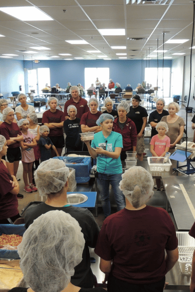 Volunteers gathered for the welcome at an FMSC packing site